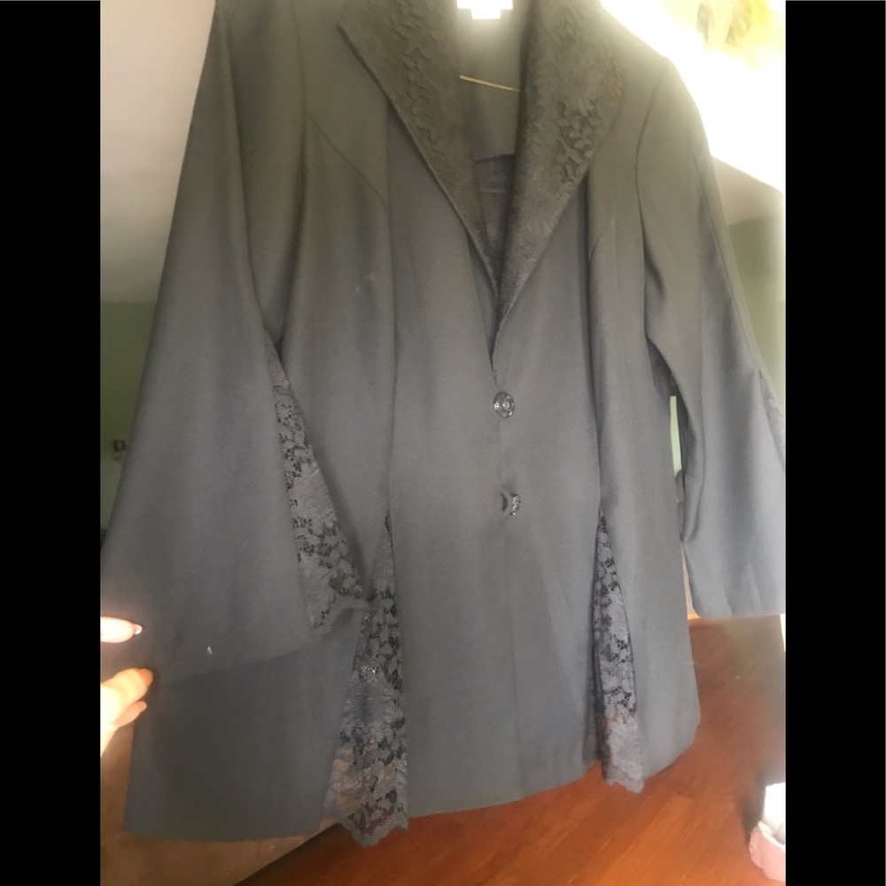 Black suit with lace trim on jacket and pants.